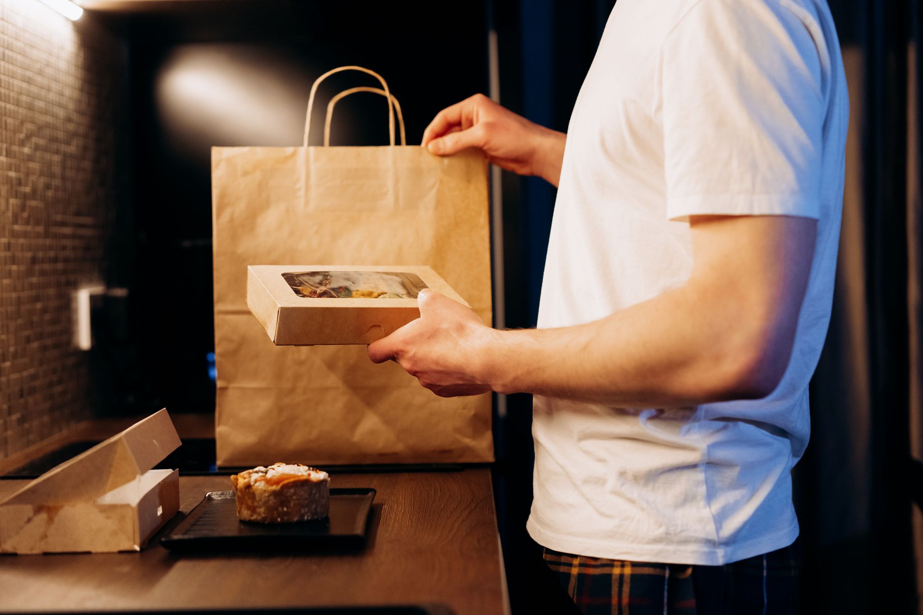 Opened UK meal kit delivery service box on a kitchen worktop showing fresh ingredients
